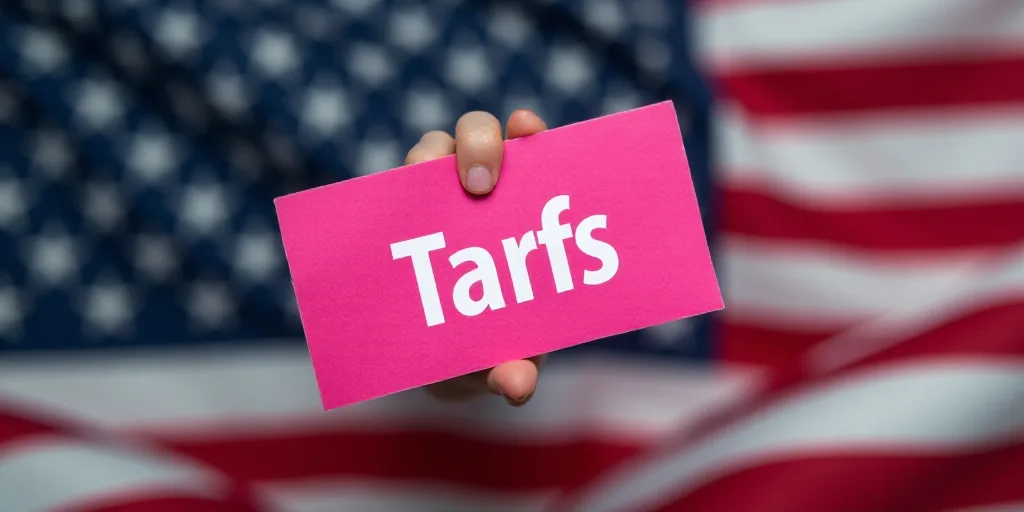 a pink sticker that says tarifs on a flag of the united states of america with stars, Clovis Trouill