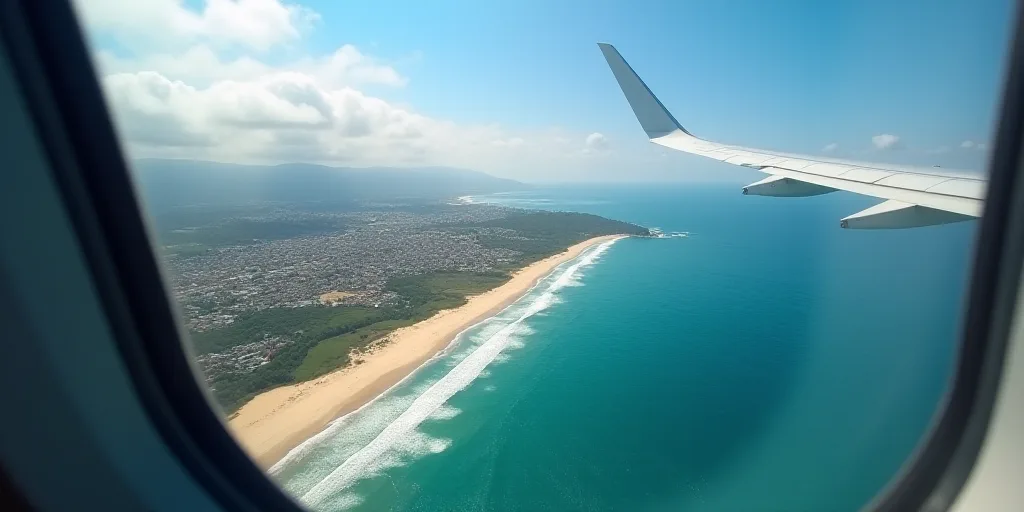 a scenic view of a beach and ocean from a plane window with a view of the ocean and a town, Bascove,