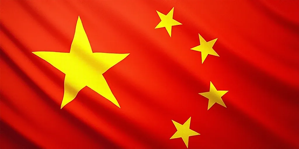 a close up of a flag with a red background and a yellow one with white stars on it and a red one wit