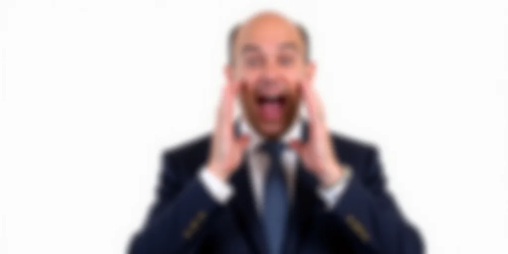 a man in a suit and tie making a face with his hands and eyes open and a white background, Dennis As