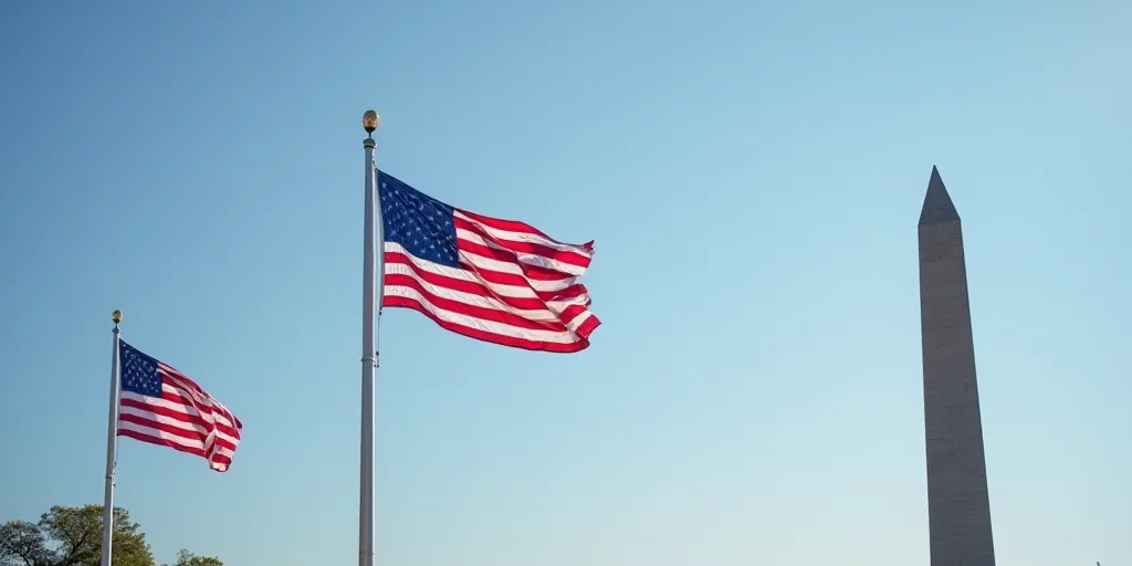 two flags are flying in the air next to a flag pole and a monument in the background with a blue sky