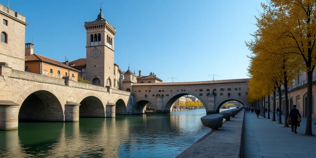 a stone bridge with arches and a clock tower in the background with a blue sky in the background and