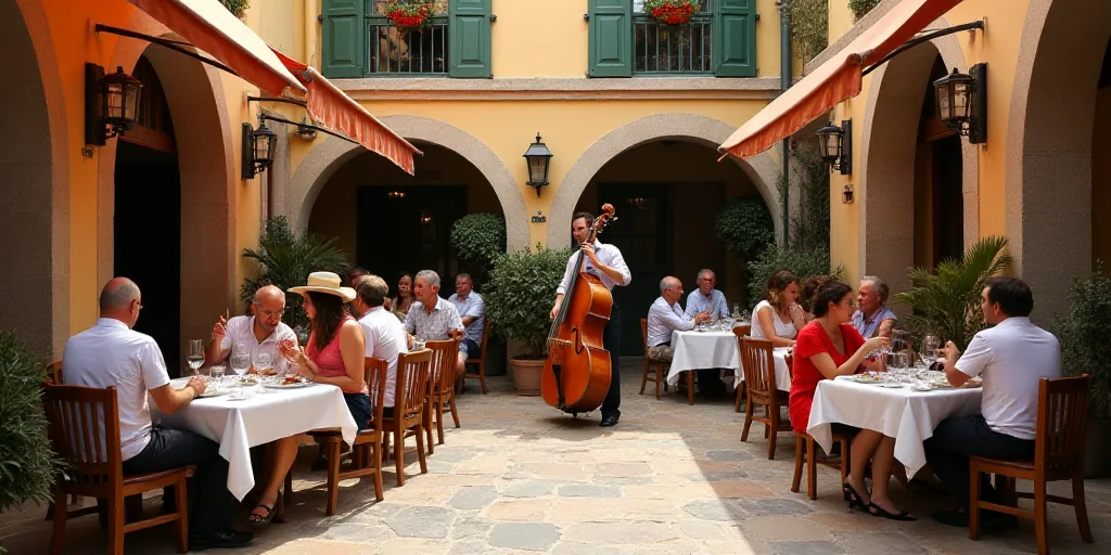 a group of people sitting around tables eating food and drinking wine in a courtyard area of a resta