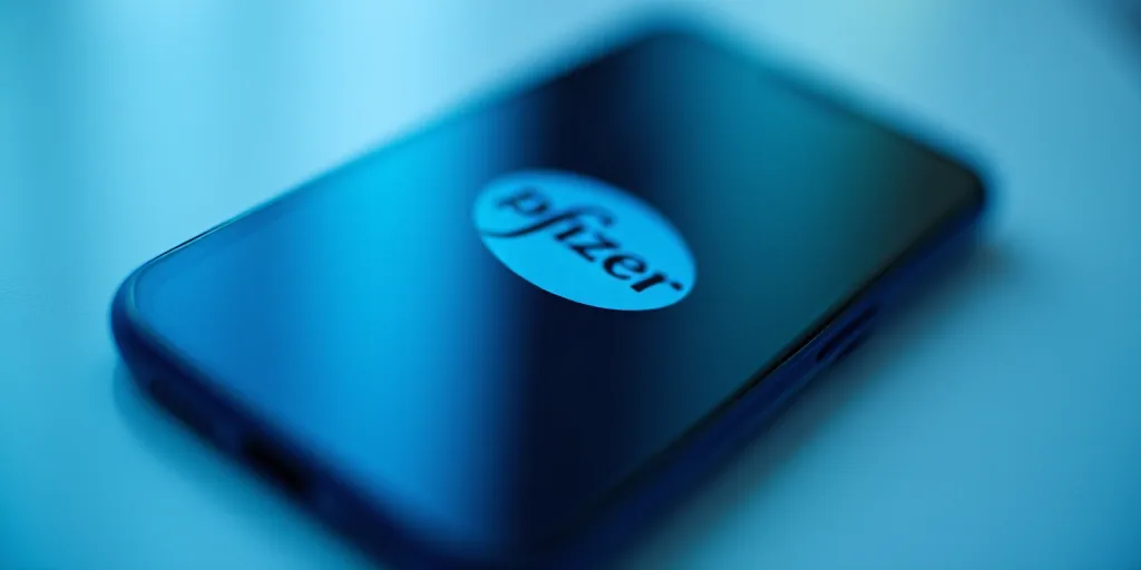 a phone with the logo of pfizer on it is shown in front of a blue and white background, Allaert van