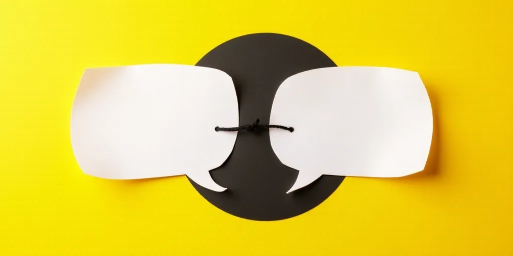 two paper speech bubbles with a black string in the middle of them on a yellow background with a bla